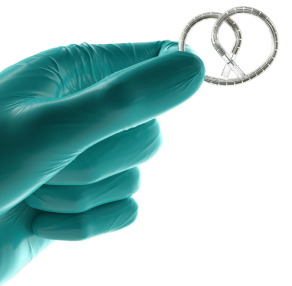 A gloved hand holding INLEXZO.
